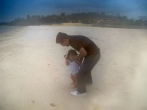Father and daughter test out the sand - Kampong Som